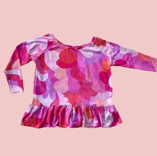 Pink and purple floral-patterned long-sleeve top on a white background