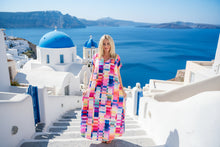Woman wearing a colorful checkered dress on a white background