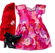 Red jacket, pink floral dress, and black high-heeled boots on a white background