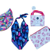 Ladies one piece swimsuit with shell pattern, colorful hat, and branded bag on a white background