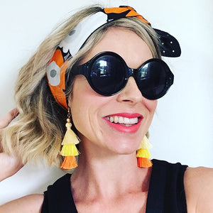 KarlaCola Orange Floral Headband Made with Marimekko Fabric worn with earrings by Sassi the Collection.